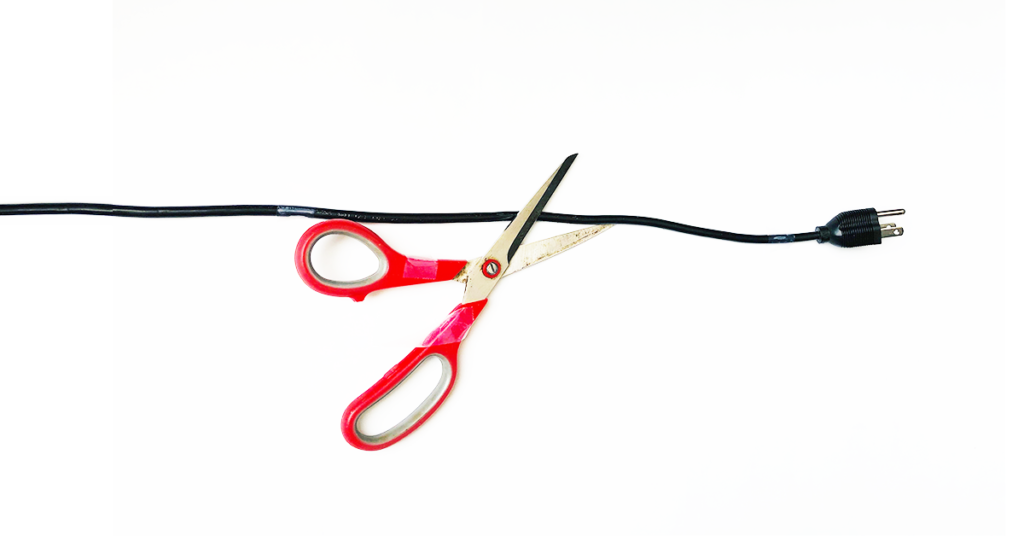 Scissor cutting the electric power cord