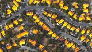 Rows of houses in a neighborhood with their roofs highlighting where the sun shines on them