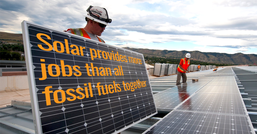 Solar workers on a roof holding a panel that says "solar provides more energy jobs than all fossil fuels together"