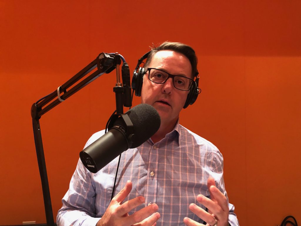 Peter Heintzleman of Cobb EMC wearing headphones and speaking into the podcast microphone